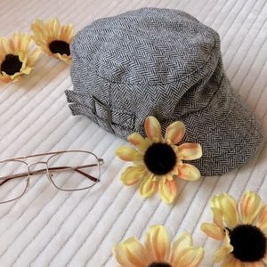 Black and white patterned hat with buckle details - one size.
